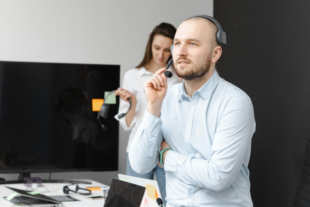 pexels-photo-7682199-7682199 A focused customer service agent using a headset in a modern office environment.